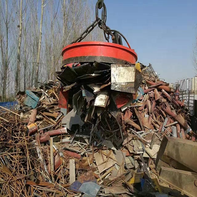 Circular Electromagnet Sorting Out Scrap Metals in Junkyard - HVR MAG