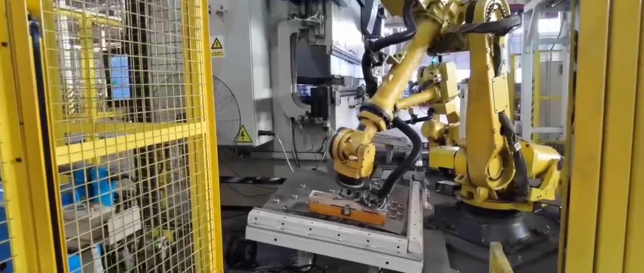 Magnetic robot gripper loading the steel strip for flaw inspection